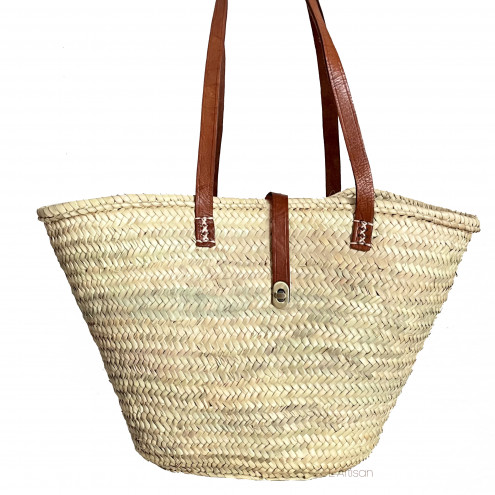 Wicker bag with leather handles and closure, handcrafted from palm leaves.