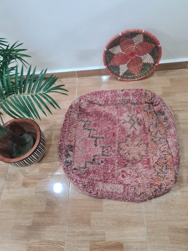Handmade Moroccan Berber pouf with wide stripes, perfect for chic home decor.