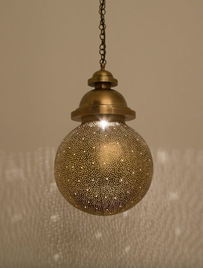 Handcrafted Moroccan ball suspension lamp with a sparkling orb and brass domes.